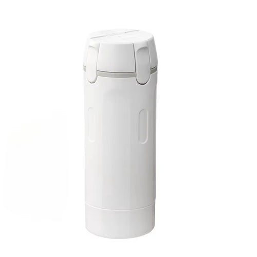 Lathrio 4-in-1 travel dispenser in white, closed, with four labelled bottles inside