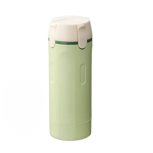 Lathrio 4-in-1 travel dispenser in sage green, closed, held in one hand